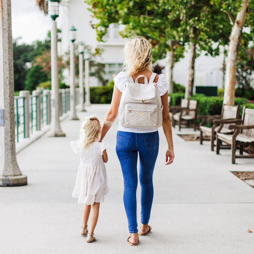Mom and daughter with the bellaboo mabel cream diaper backpack