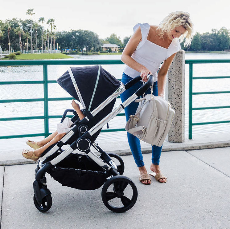 Active Mom Using a Stroller with Diaper Changing Bag in Cream